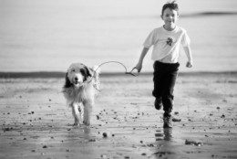3505497_s picture of kid running on beach with dog