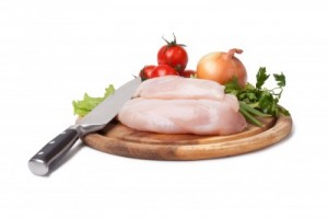picture of chicken breast and vegetables on cutting board