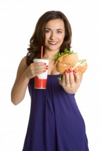 picture of woman eating burger and cola