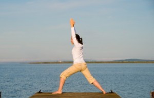 picture of woman doing tai chi on beach