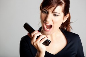 picture of mad woman screaming into telephone