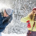 picture of Portrait of beautiful woman holding snow and smiling