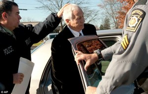 picture of Jerry Sandusky being arrested by police for sex abuse on minors