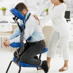 picture of Businessman sitting on massage chair, getting back massage. 