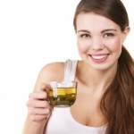 picture of Young beautiful woman with a cup of green tea, white background