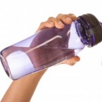 picture of Dark skinned ethnic female holding bottle of water
