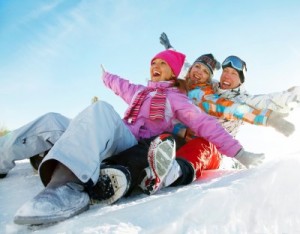 picture of father, mother and daughter on slide downhill in wintertime