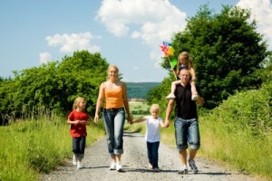 picture of Happy family walking down a path on a bright summer day 