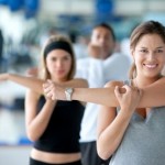 picture of Woman doing stretching exercises for her arm at the gym
