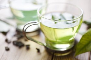 picture of close up of green tea or generic herbal tea, very shallow focus on the front of the cup 