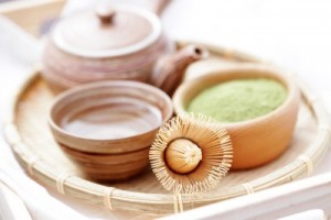 picture of green powder tea with bamboo whisk - tea time