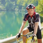 picture of senior man on road bike, looking at camera. 