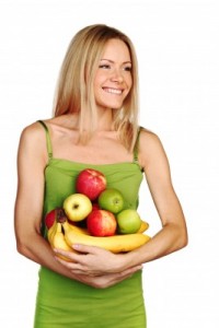 picture of woman holds a pile of fruit on a white background